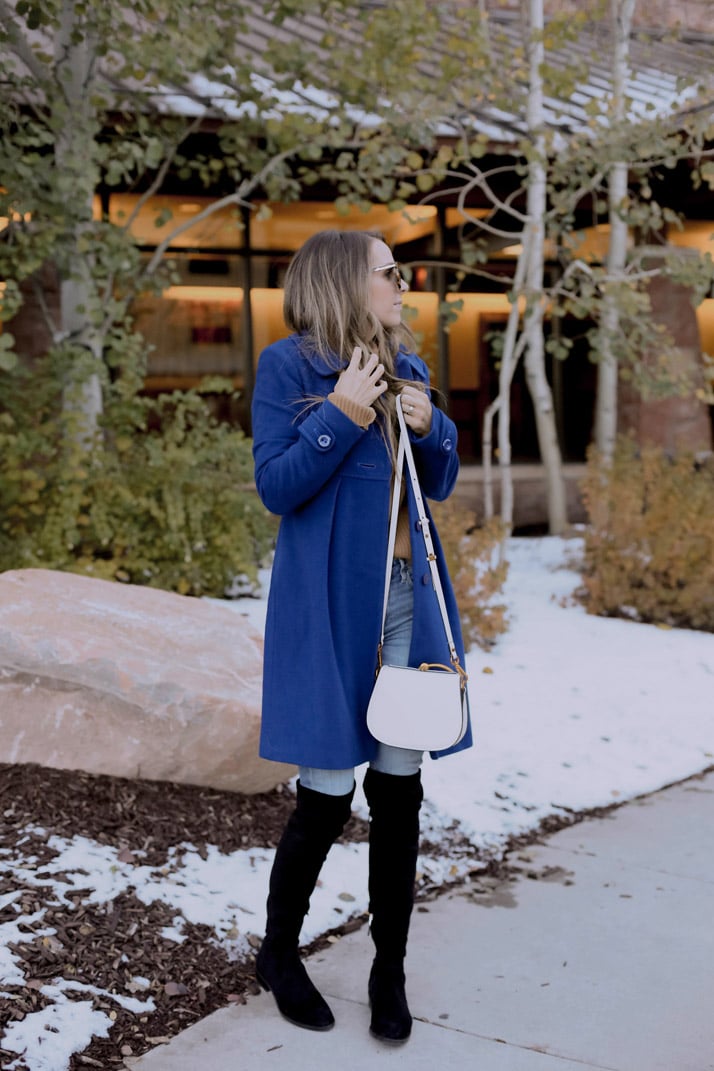 blue coat and black boots