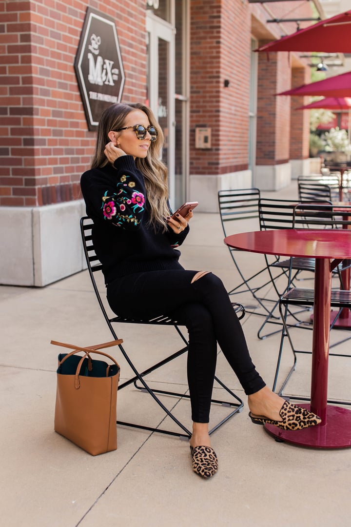 black embroidered sweater, black jeans and leopard loafers
