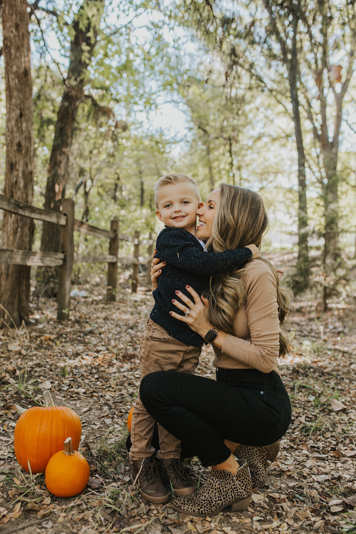 hugging mom and son with pumpkins