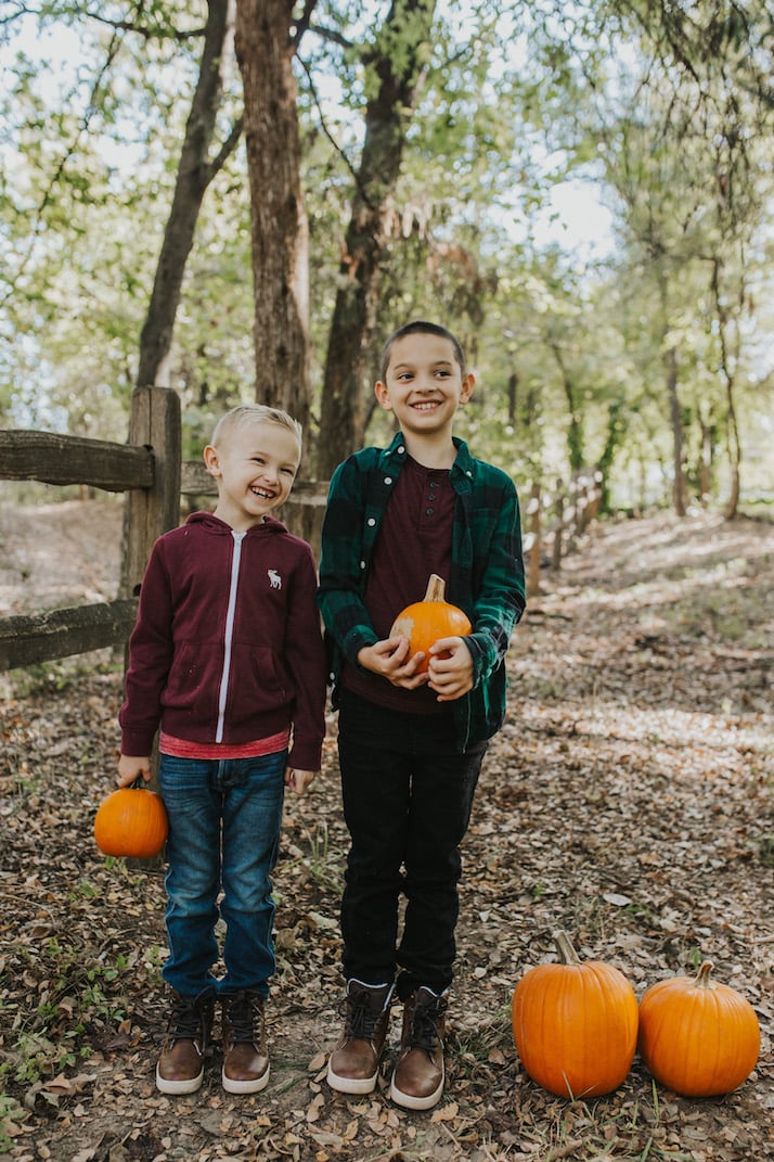 boys in fall clothes with pumpkins