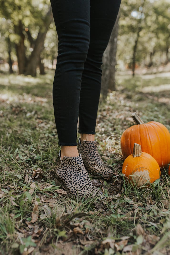 leopard print ankle boots and black jeans