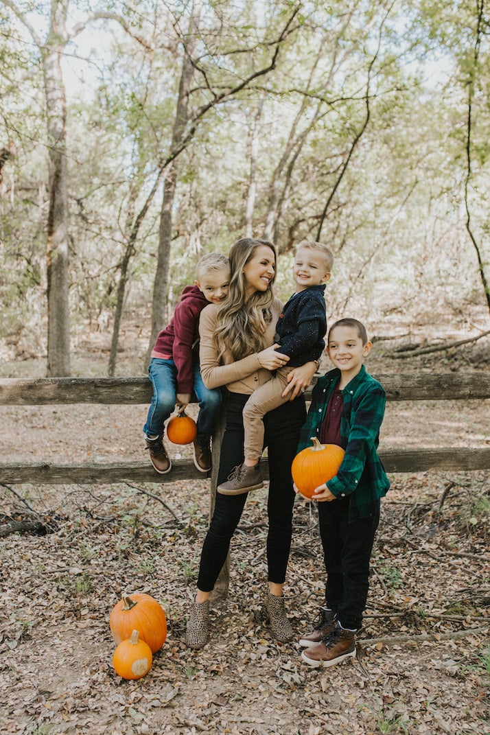 mom and sons in a pumpkin patch