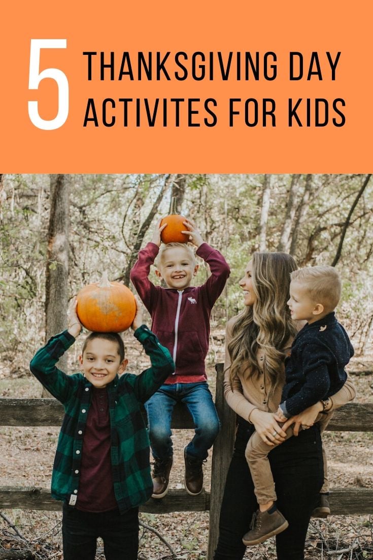 boys and mom with pumpkins on a fence