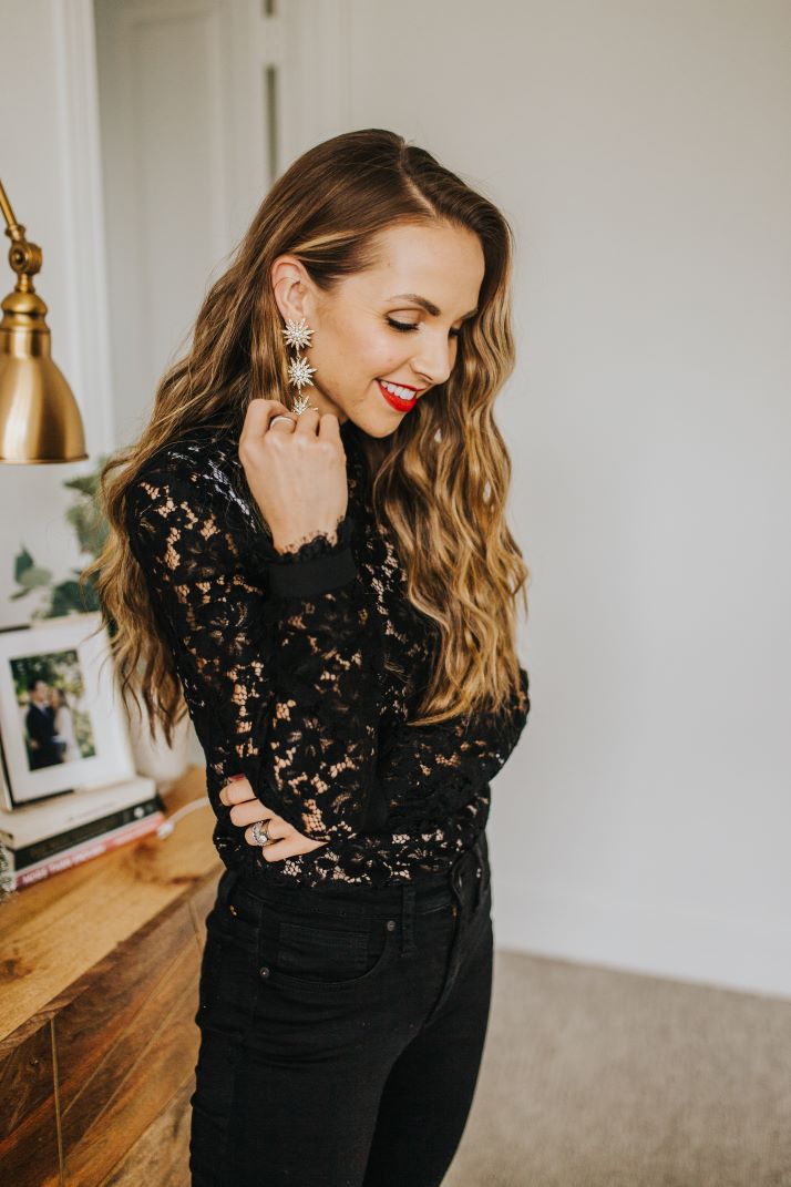 black lace top with wavy hair and red lipstick