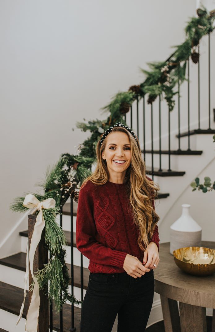 cable knit burgundy sweater with black jeans and pearl headband