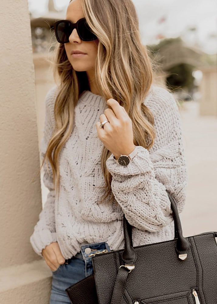 round watch and black purse