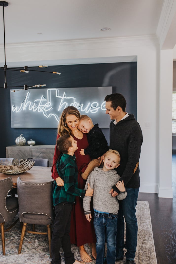 family in dining room with neon light