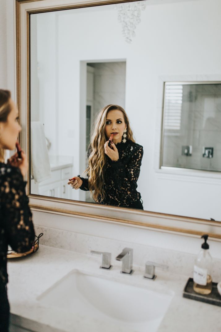 putting on lipstick in the mirror velvet teddy mac