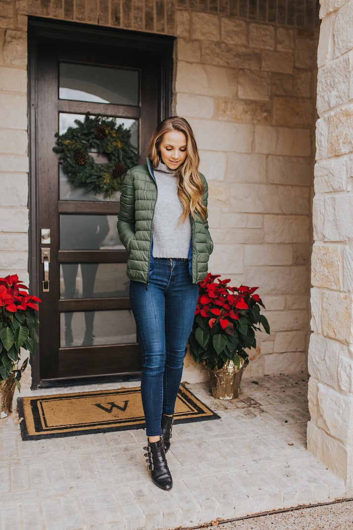 merrick on front porch with poinsettas in green puffer jacket