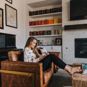 leather armchair with rainbow bookshelves
