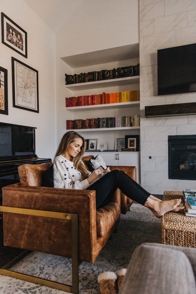 leather armchair with rainbow bookshelves