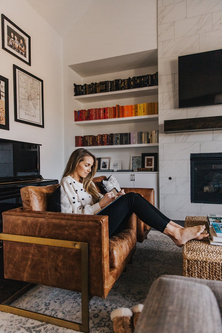 leather armchair with rainbow bookshelves