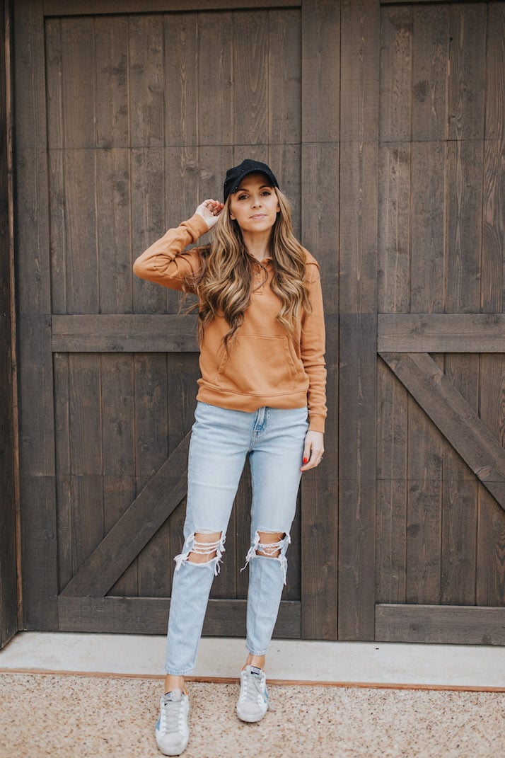 light wash jeans, baseball cap, hoodie