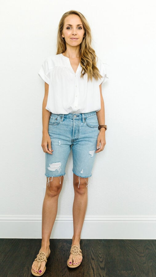 denim shorts, white shirt, with a baseball cap