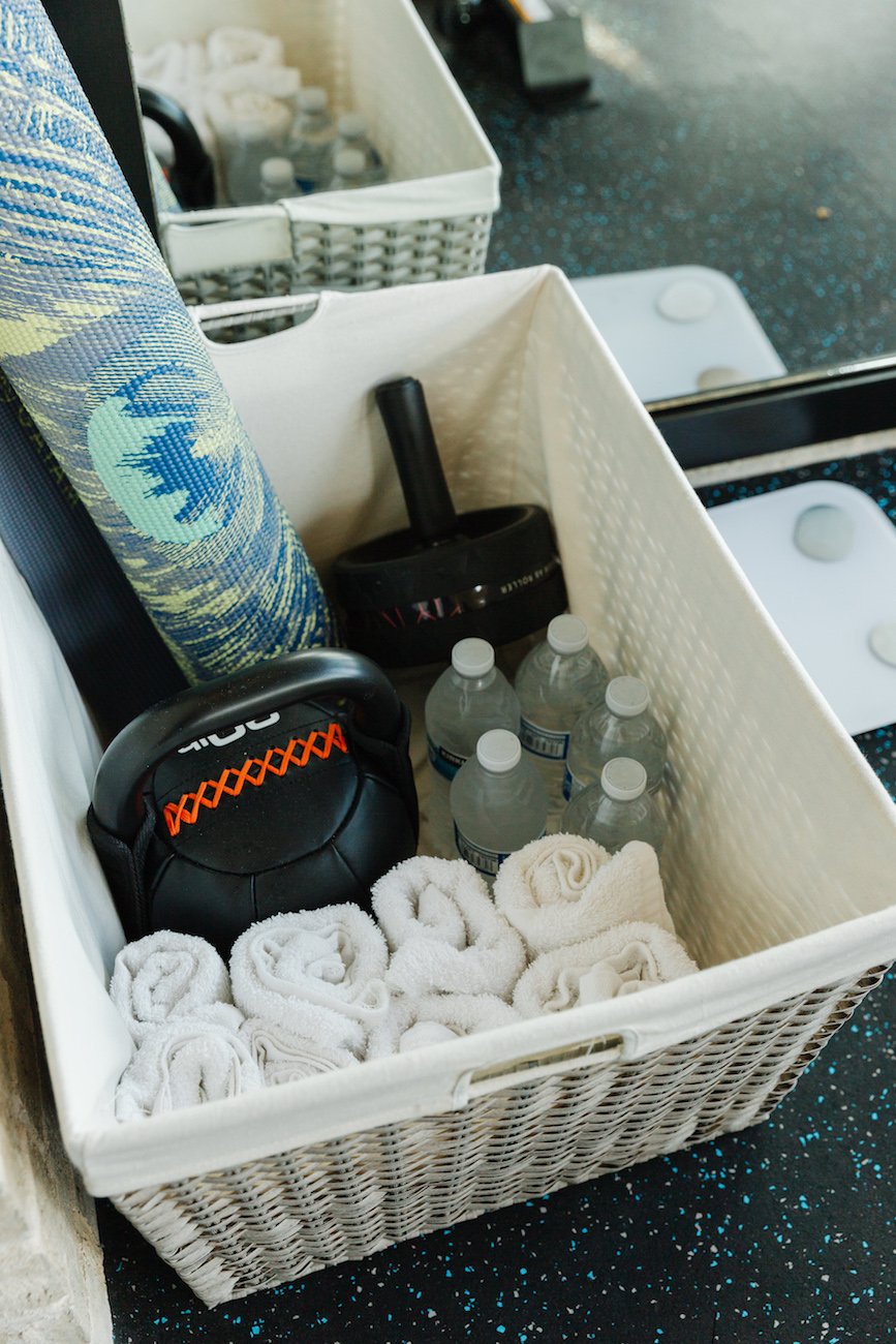 storage basket with yoga mat and water and towels