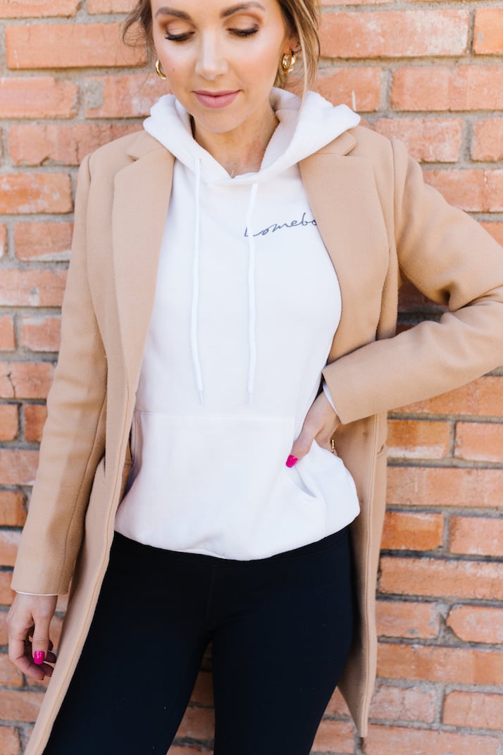 white hoodie with tan coat