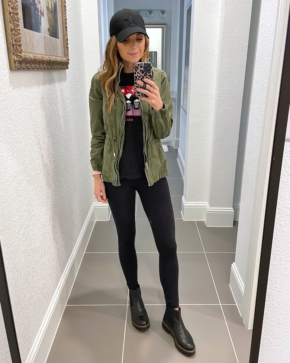 green jacket with black leggings
