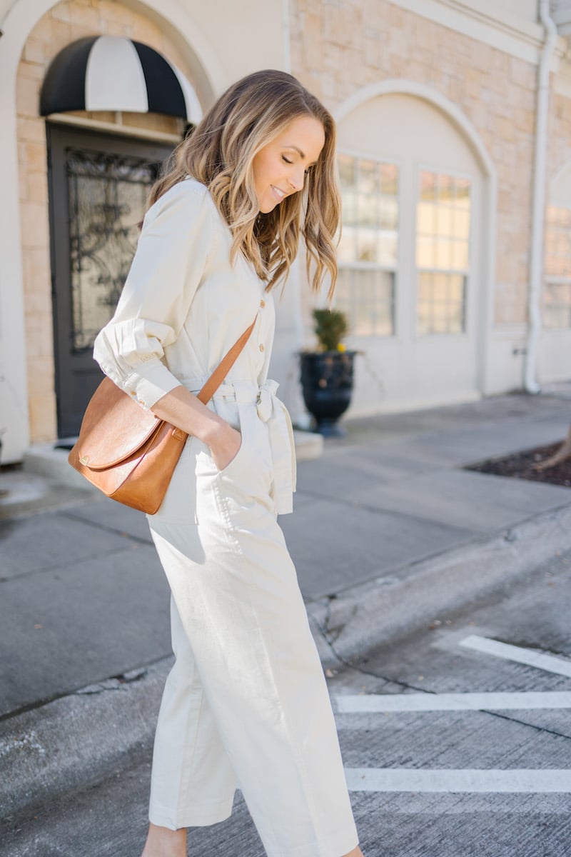 cream jumpsuit with crossbody bag