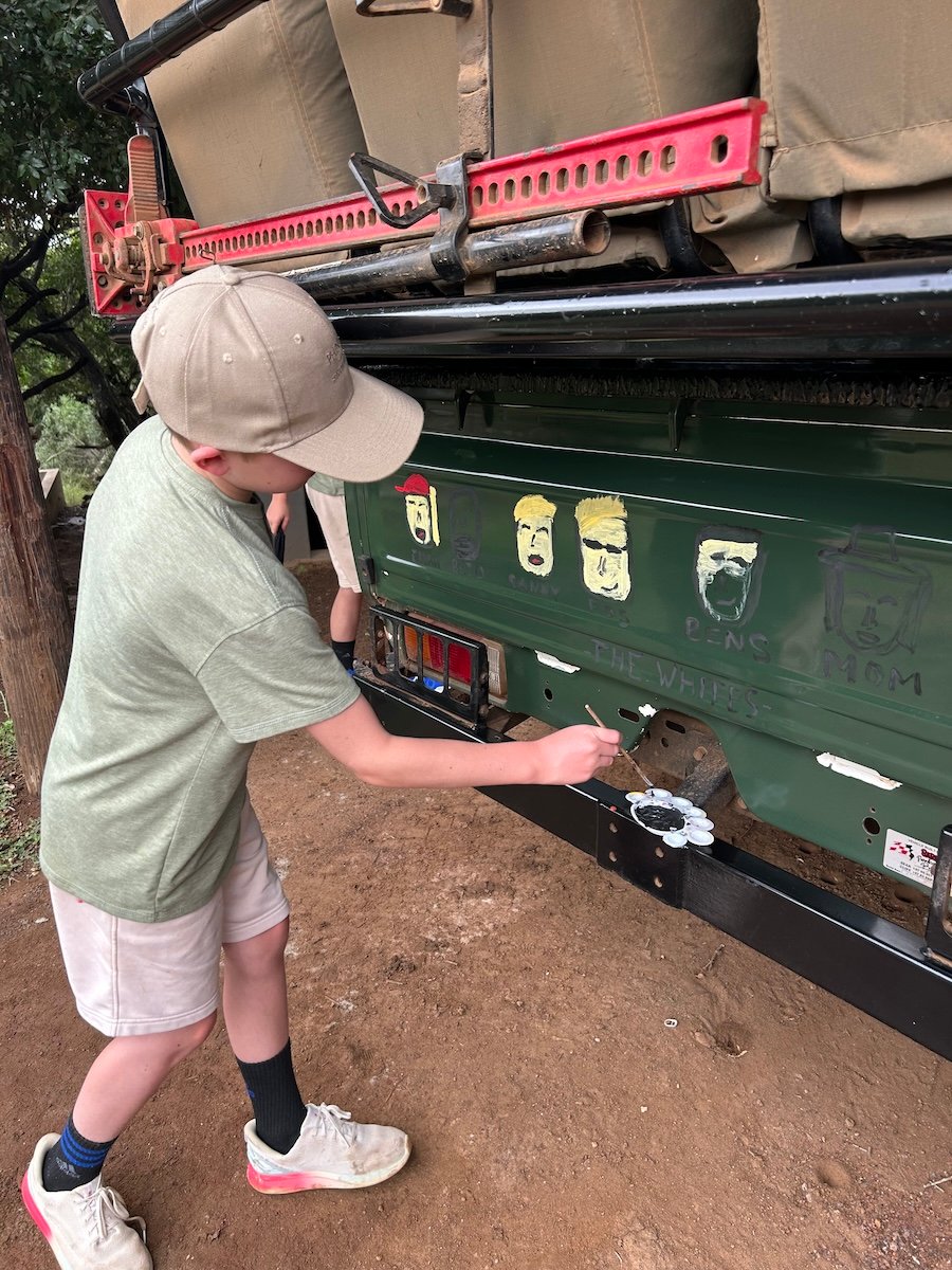 boys painting vehicle safari