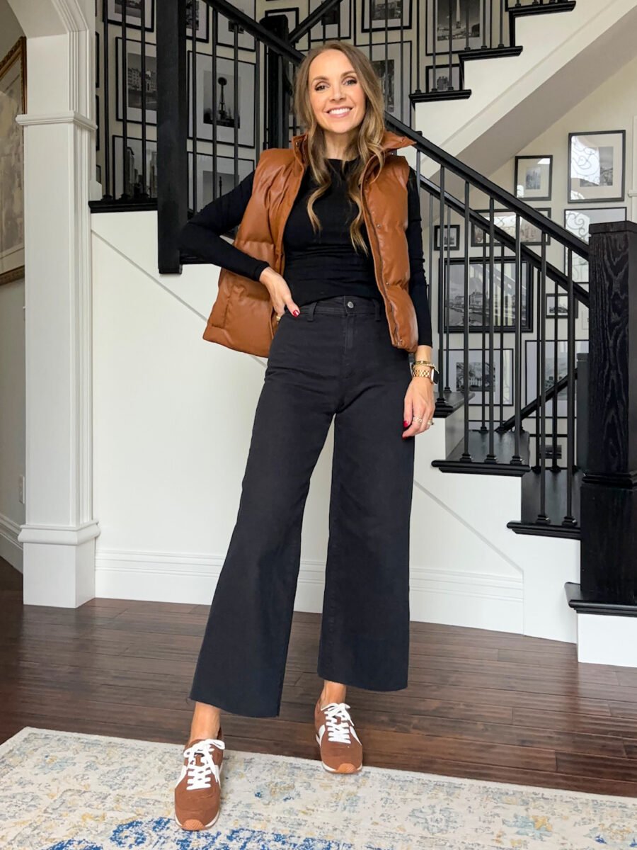 black pants with black tee and rust puffer vest