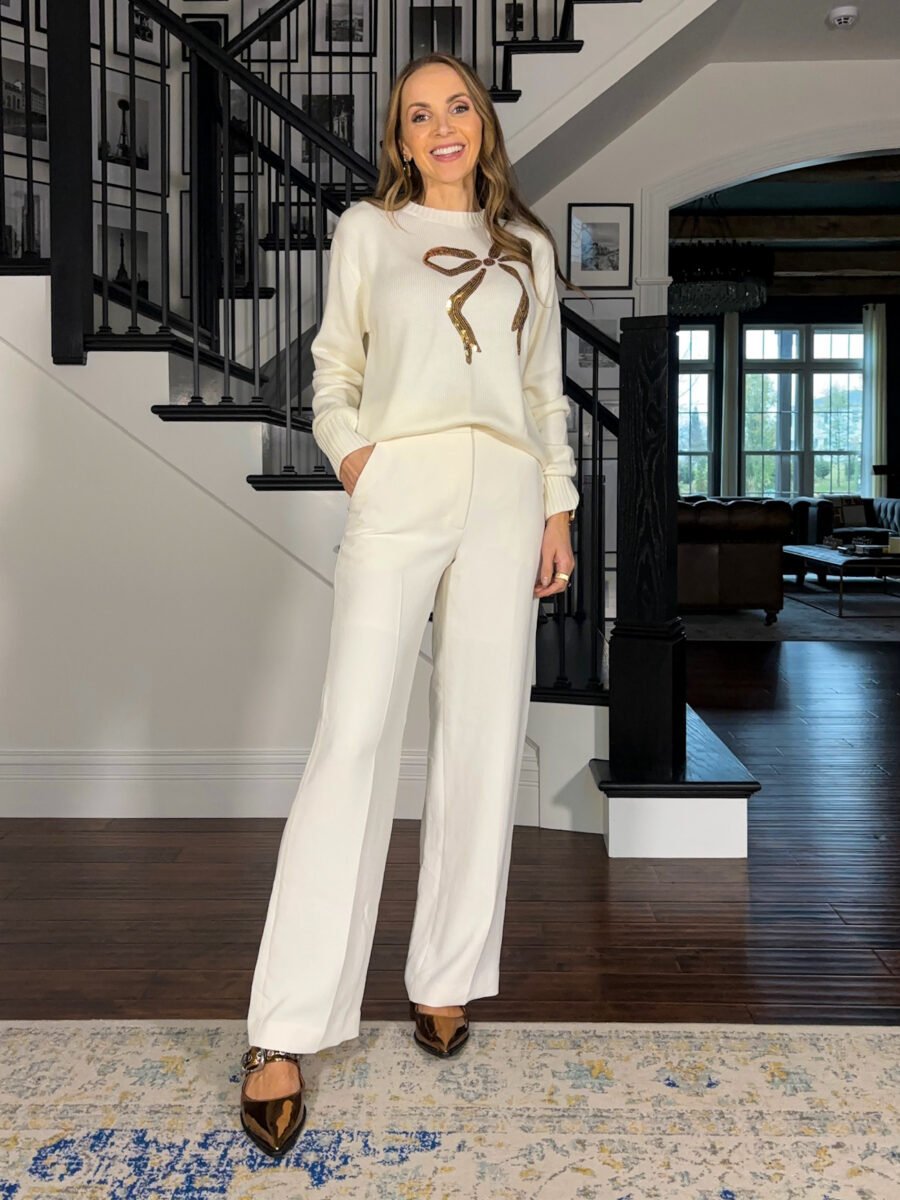 Holiday sweater outfits - Anthro bow sweater, aritzia cream pants, anthro flats, j crew factory earrings